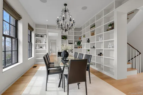 a view of a dining room with furniture and a chandelier