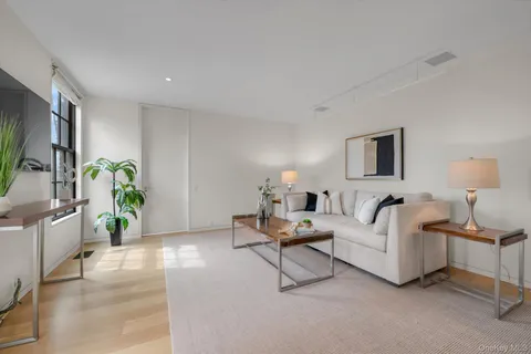 a living room with furniture and a lamp
