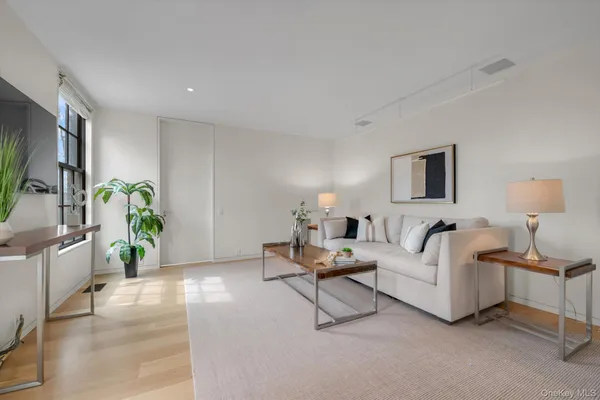 a living room with furniture and a lamp