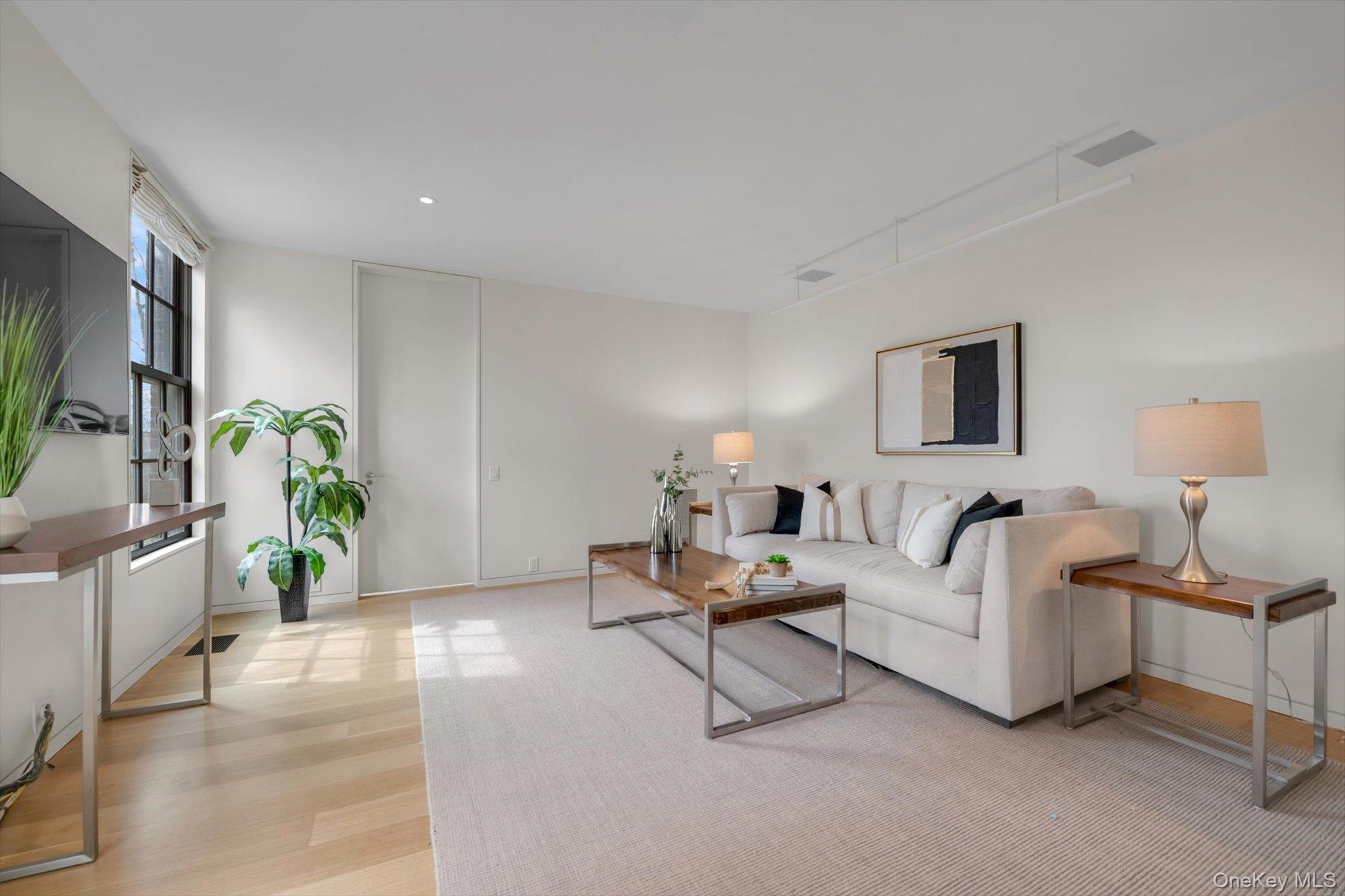 217 Sands Point Road Sands Point, NY 11050 - Photo 12 of 39 a living room with furniture and a lamp