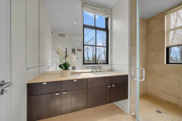 a bathroom with a double vanity sink and a mirror