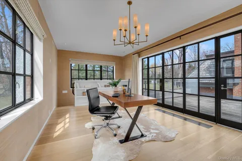 a living room filled with furniture and a chandelier