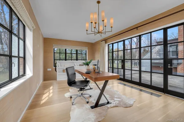 a living room filled with furniture and a chandelier