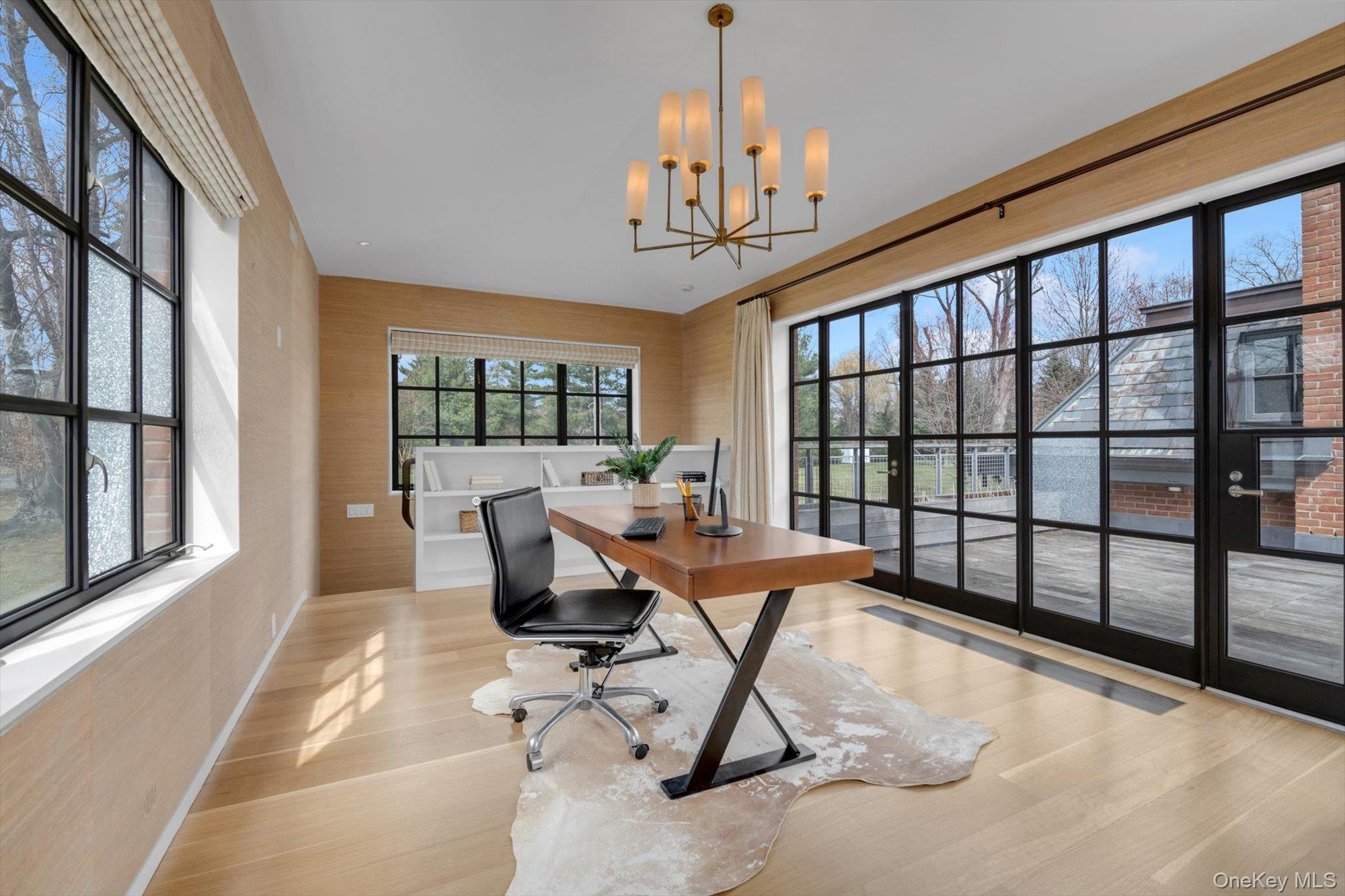 217 Sands Point Road Sands Point, NY 11050 - Photo 21 of 39 a living room filled with furniture and a chandelier