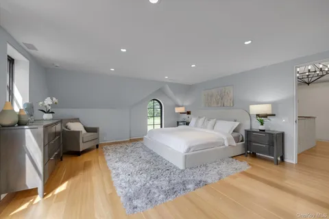 a spacious bedroom with a bed and a couch
