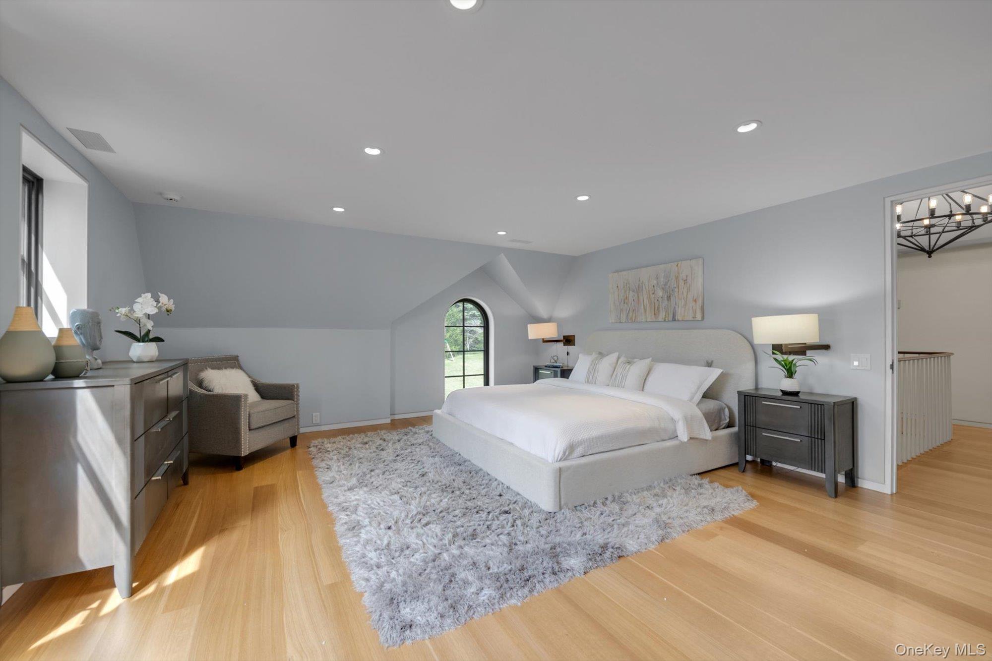 217 Sands Point Road Sands Point, NY 11050 - Photo 23 of 39 a spacious bedroom with a bed and a couch