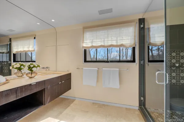 a bathroom with a double vanity sink and a mirror