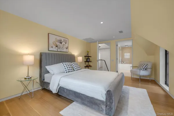 a spacious bedroom with a bed and a table
