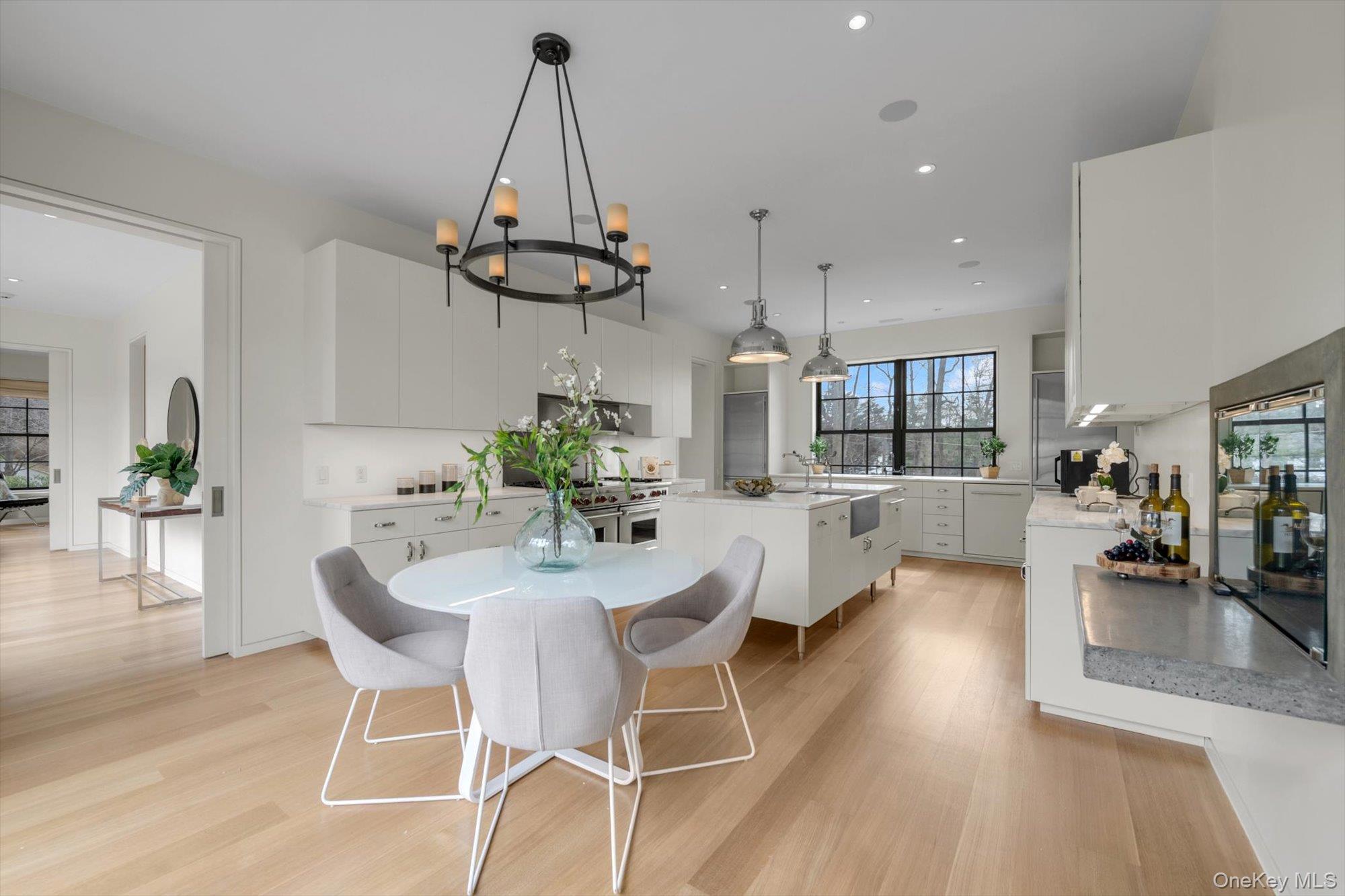 217 Sands Point Road Sands Point, NY 11050 - Photo 3 of 39 a view of a dining room and livingroom with furniture wooden floor a chandelier