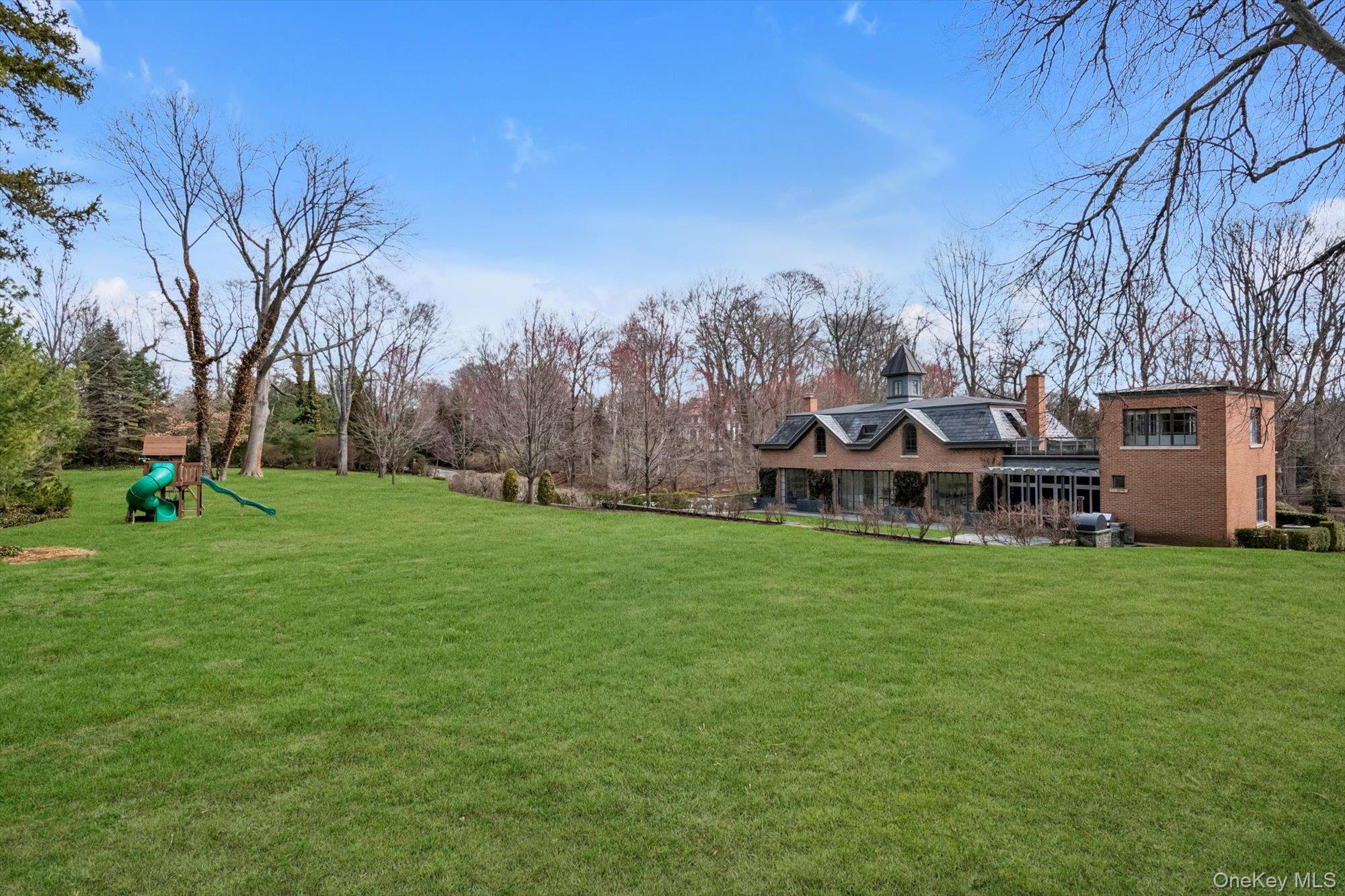 217 Sands Point Road Sands Point, NY 11050 - Photo 38 of 39 a view of a house with a backyard