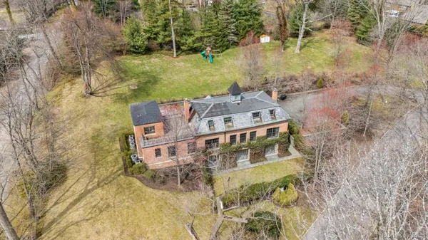 aerial view of a house with a yard