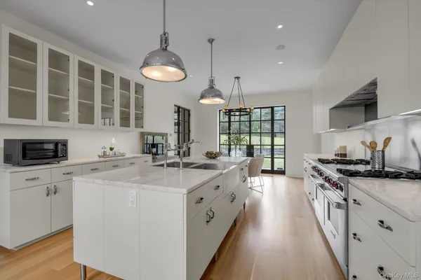 a kitchen with stainless steel appliances granite countertop a sink stove and cabinets
