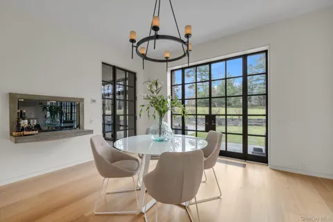 a dining room with furniture a chandelier and wooden floor
