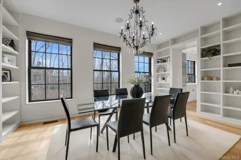 a view of a dining room with furniture and a chandelier