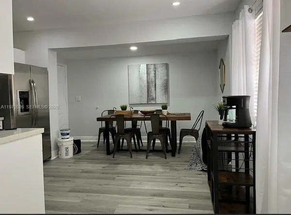 a view of a a dining room with furniture and wooden floor