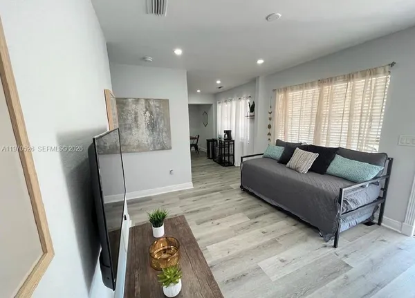 a living room with furniture and a window