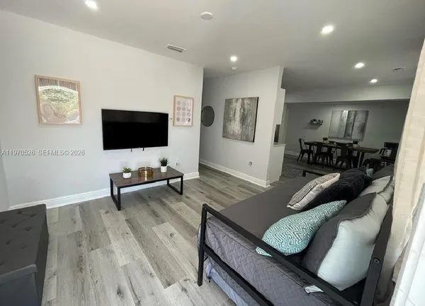 a living room with furniture and a flat screen tv