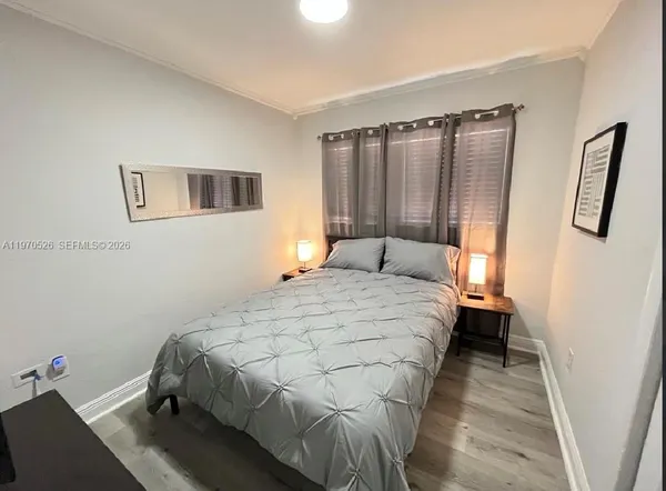 a bedroom with a bed and a mirror