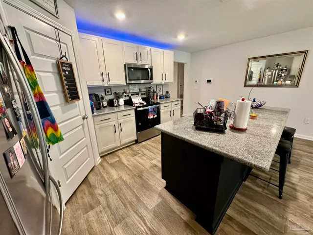 a kitchen with appliances cabinets and a counter space