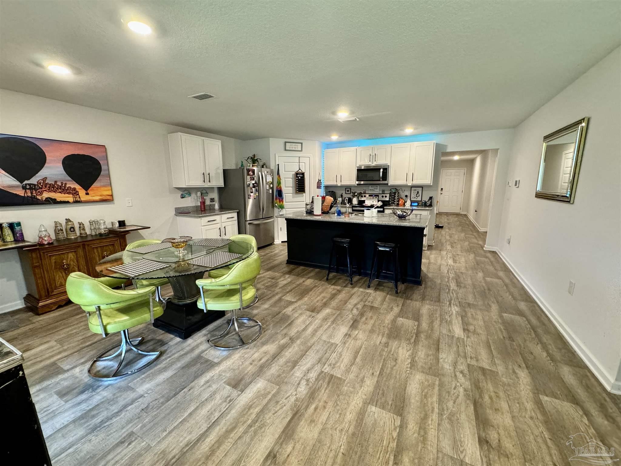 5645 Guinevere Lane Milton, FL 32583 - Photo 16 of 24 a living room with furniture and a couch