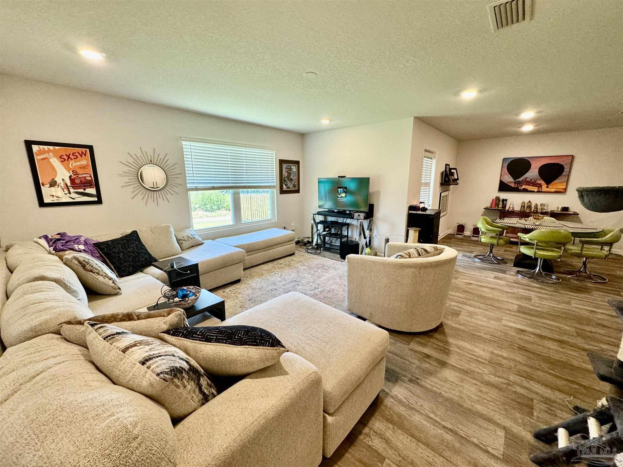 5645 Guinevere Lane Milton, FL 32583 - Photo 18 of 24 a living room with furniture wooden floor and window