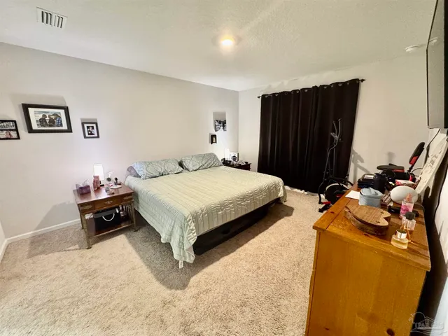 a bedroom with a bed and furniture