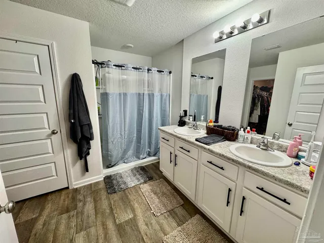 a bathroom with a double vanity sink and mirror