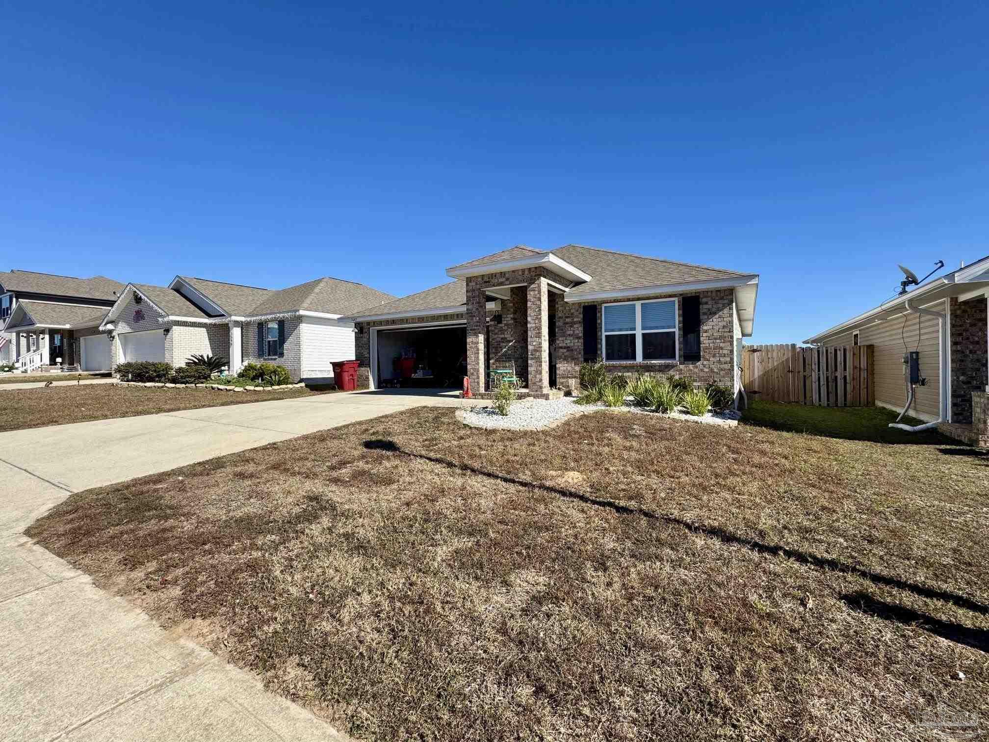 5645 Guinevere Lane Milton, FL 32583 - Photo 2 of 24 a front view of a house with a yard