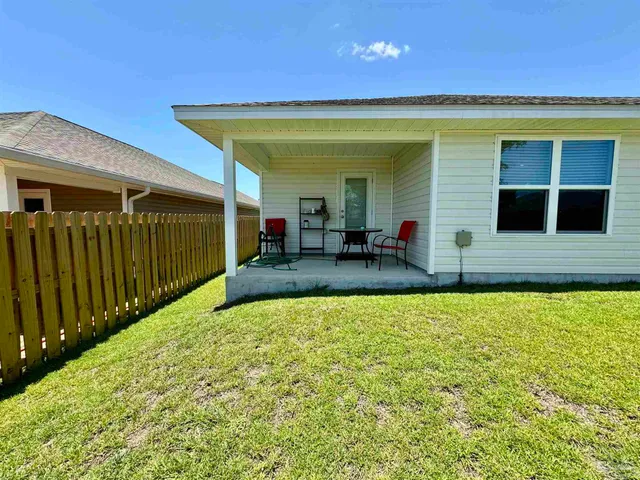 a view of a house with swimming pool in front of it