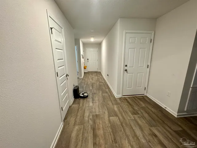 a view of a room with wooden floor