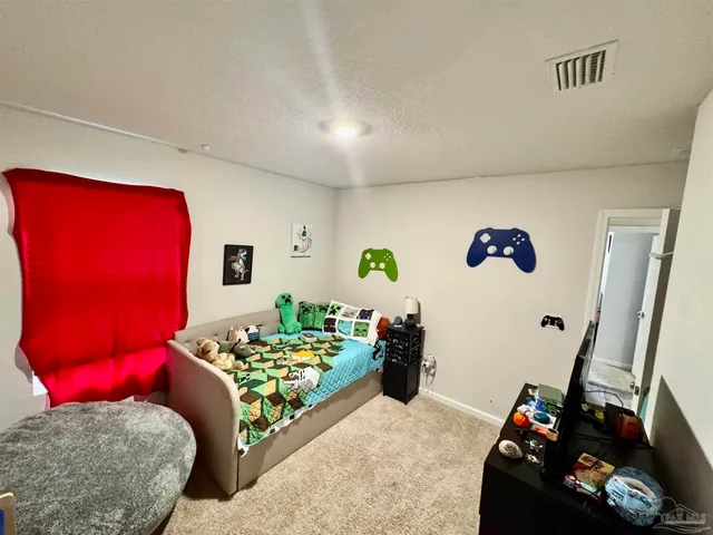 a bedroom with furniture and a wooden floor