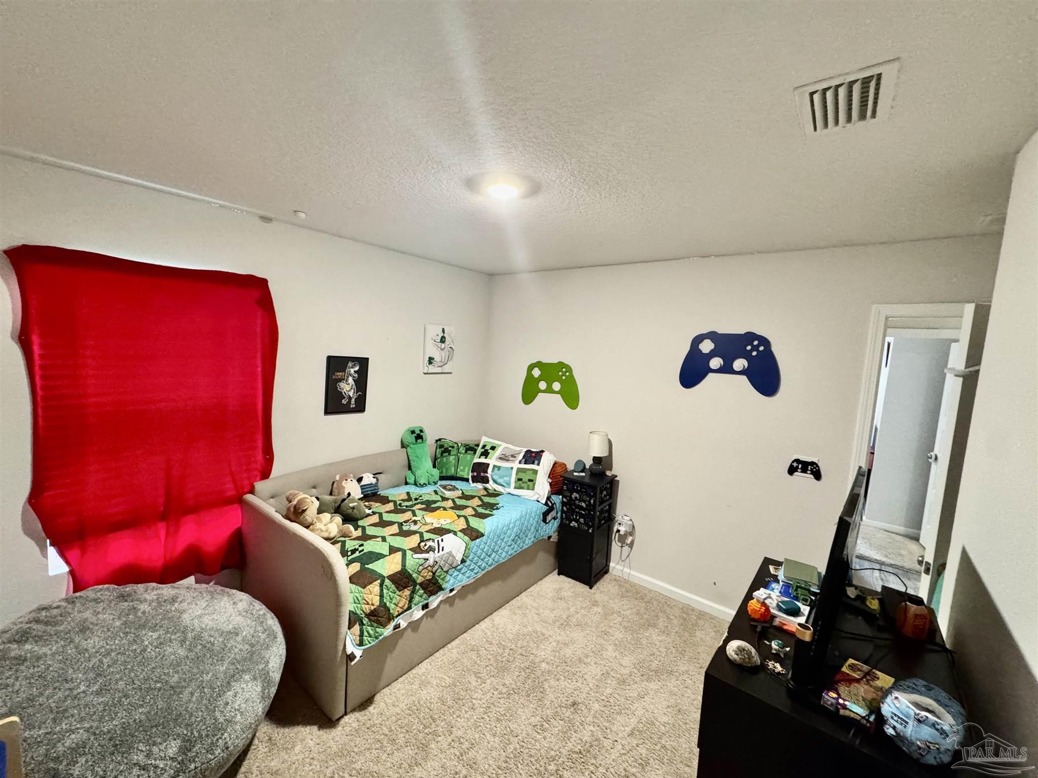 5645 Guinevere Lane Milton, FL 32583 - Photo 8 of 24 a bedroom with furniture and a wooden floor