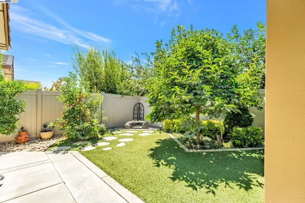 a front view of a house with a yard and a garage