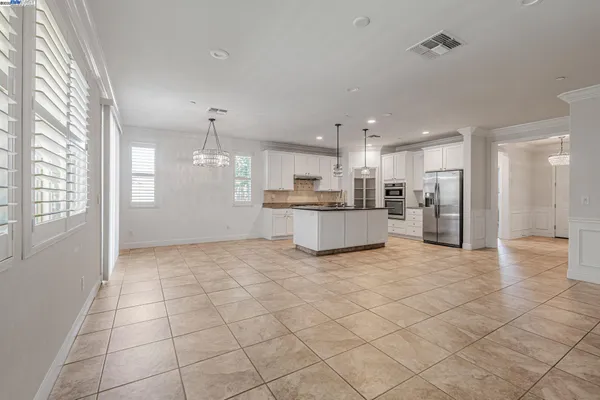 a kitchen with stainless steel appliances kitchen island granite countertop a sink and cabinets