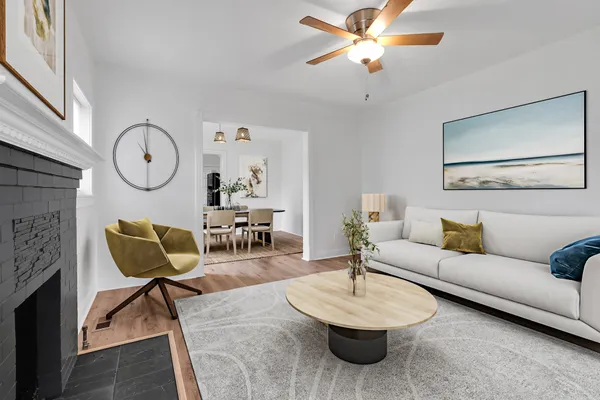 a living room with furniture a rug and a fireplace