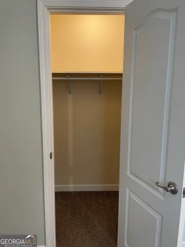 a bathroom with a granite countertop toilet and a shower