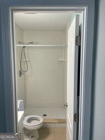 a bathroom with a toilet a sink and a mirror