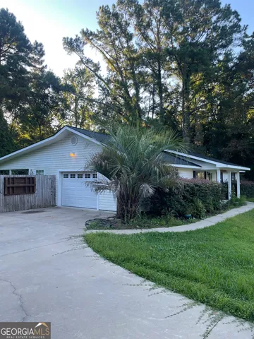 a house that has a tree in front of it