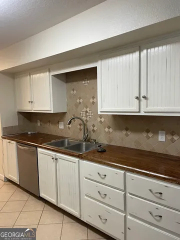 a kitchen with stainless steel appliances a refrigerator and a sink