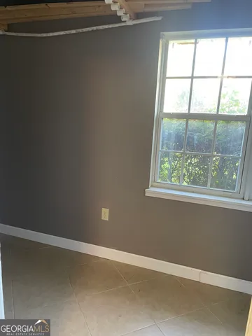 a view of room with walk in closet and window