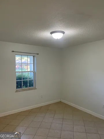 an empty room with a empty space and windows