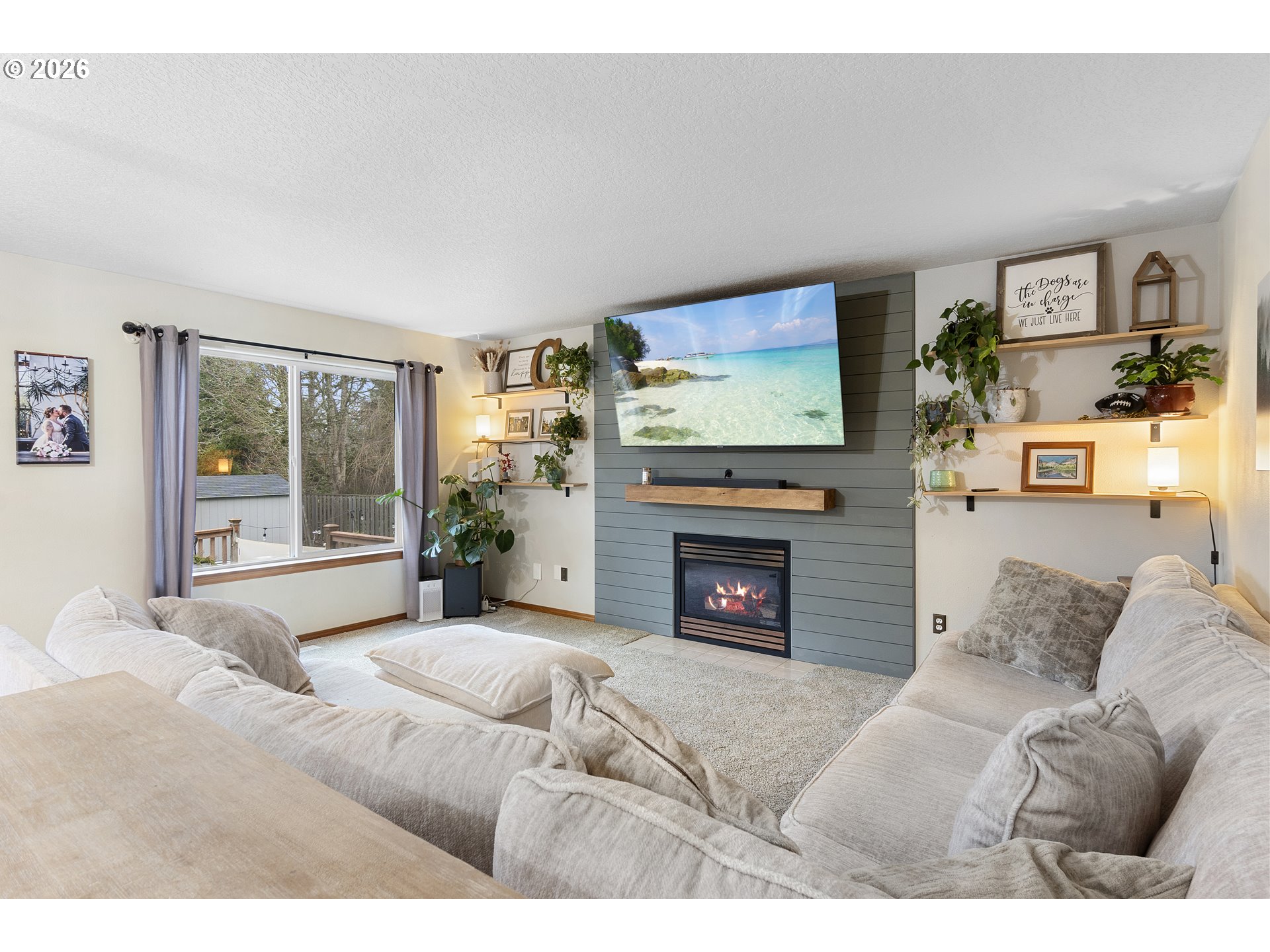 13177 Moccasin Way Oregon City, OR 97045 - Photo 14 of 44 a living room with furniture a flat screen tv and a fireplace