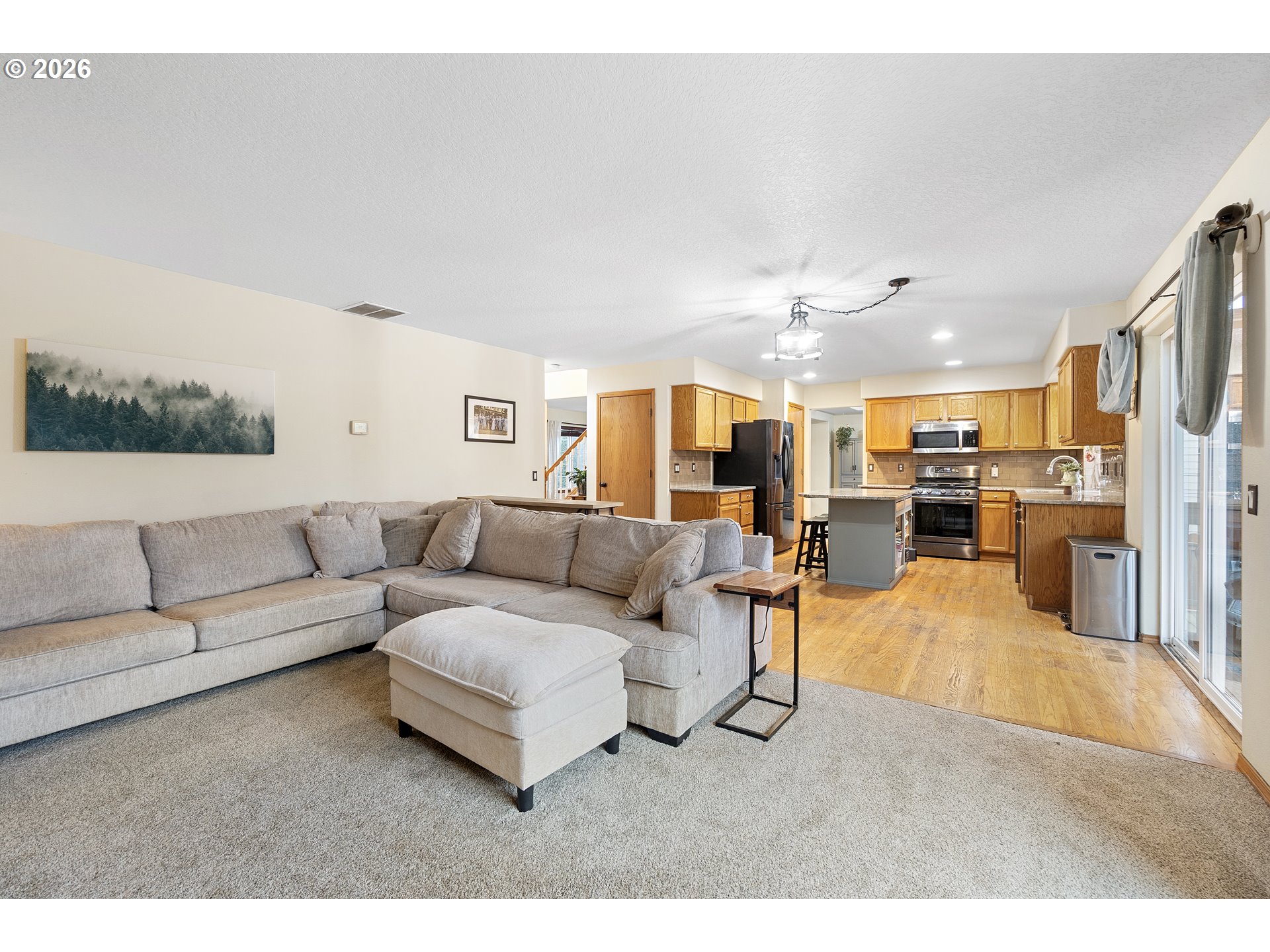 13177 Moccasin Way Oregon City, OR 97045 - Photo 16 of 44 a living room with furniture and a kitchen view