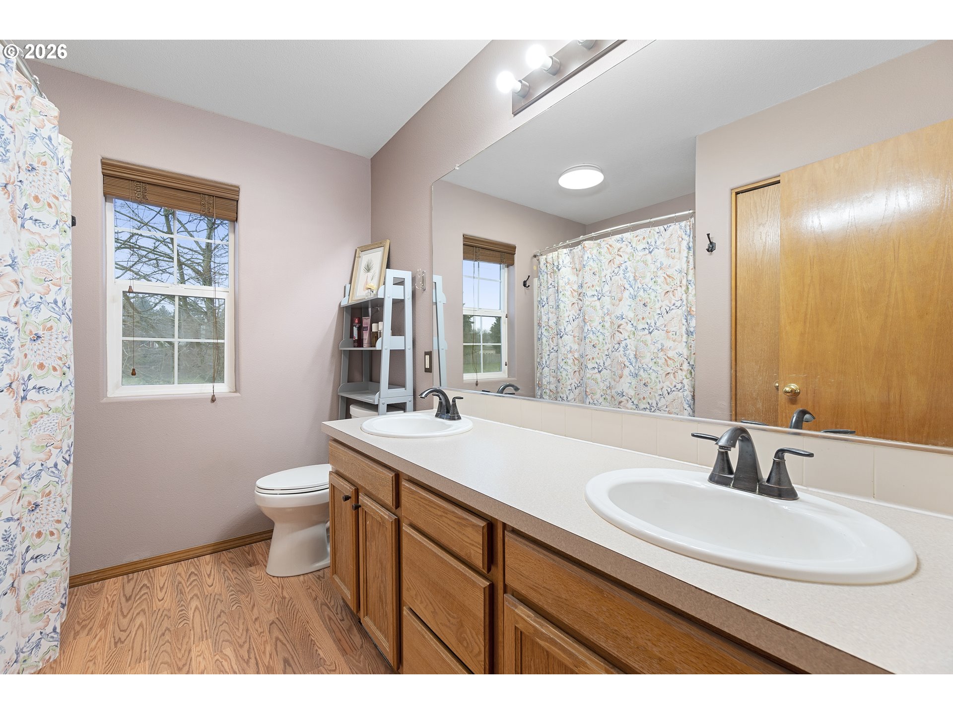 13177 Moccasin Way Oregon City, OR 97045 - Photo 24 of 44 a bathroom with a sink a toilet a mirror and a window