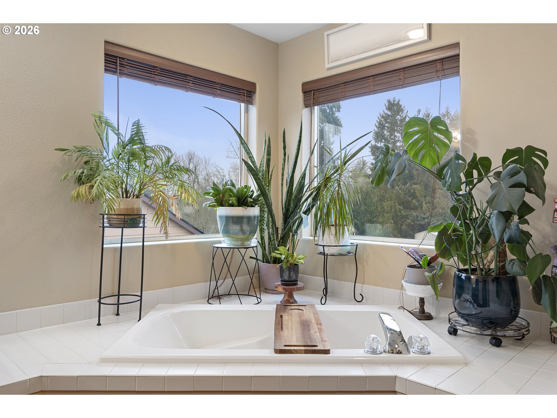 13177 Moccasin Way Oregon City, OR 97045 - Photo 28 of 44 a vase of flowers sitting on a table with a potted plant