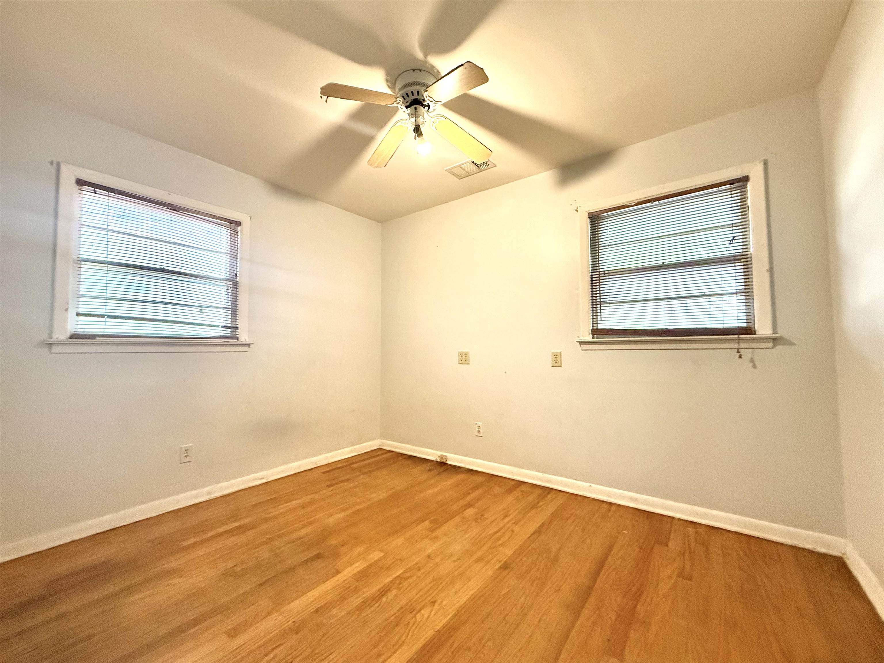 2930 Getwell Road Memphis, TN 38118 - Photo 12 of 25 Hardwood flooring paired with a ceiling fan light fixture