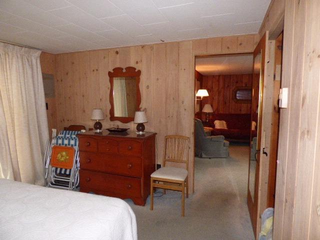 75 Beaten Road, Unit 9 Dennis Port, MA 02639 - Photo 11 of 14 a bedroom with a bed and a mirror