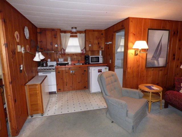 75 Beaten Road, Unit 9 Dennis Port, MA 02639 - Photo 2 of 14 a kitchen with cabinets and chairs