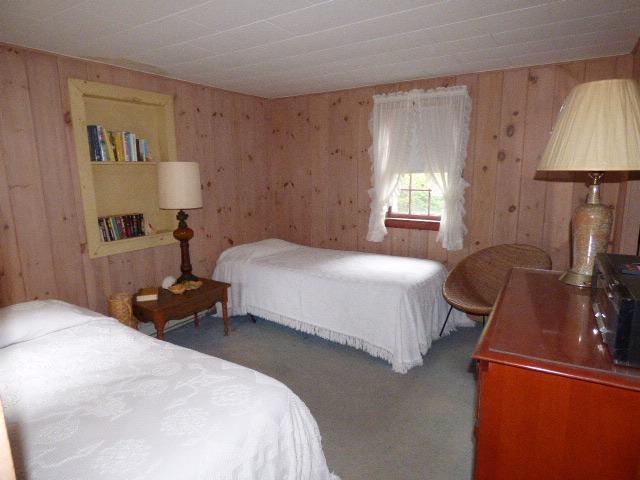 75 Beaten Road, Unit 9 Dennis Port, MA 02639 - Photo 8 of 14 a bedroom with a bed and a lamp