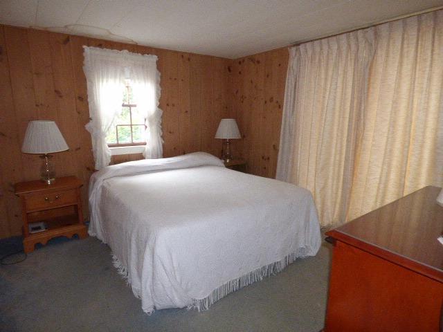 75 Beaten Road, Unit 9 Dennis Port, MA 02639 - Photo 10 of 14 a bedroom with a bed and a window